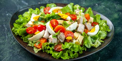 top-view-homemade-delicious-salad-with-many-ingredients-plate-black-green-mix-colors-background (1)